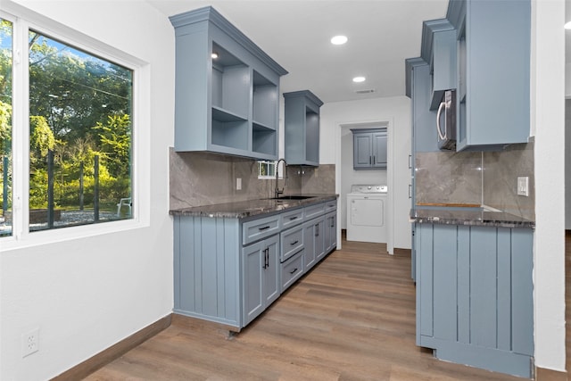 kitchen with sink, dark hardwood / wood-style flooring, and a healthy amount of sunlight