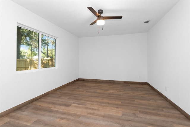 spare room with ceiling fan and dark hardwood / wood-style floors