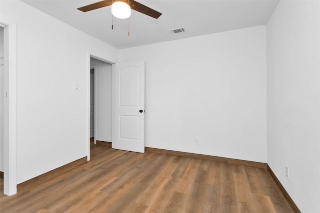 unfurnished bedroom with ceiling fan and hardwood / wood-style floors