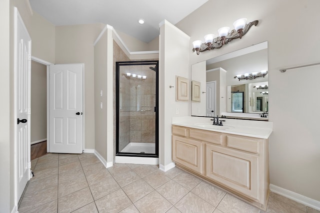 bathroom with tile patterned flooring, walk in shower, and vanity