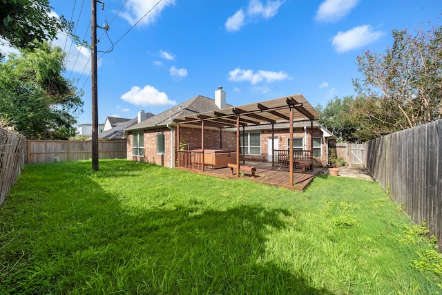 rear view of house with a wooden deck and a lawn