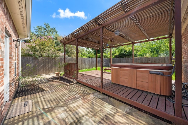 wooden deck with a pergola, a patio area, and a hot tub