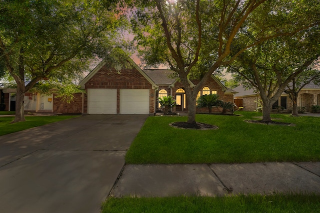 view of front of property with a front yard and a garage