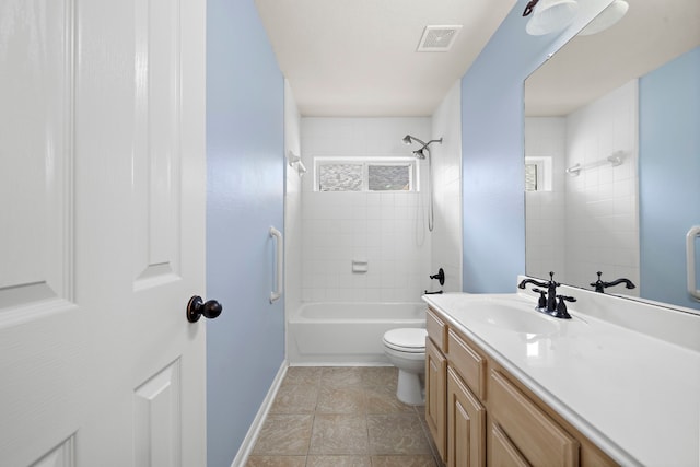 full bathroom with tile patterned floors, vanity, toilet, and tiled shower / bath combo