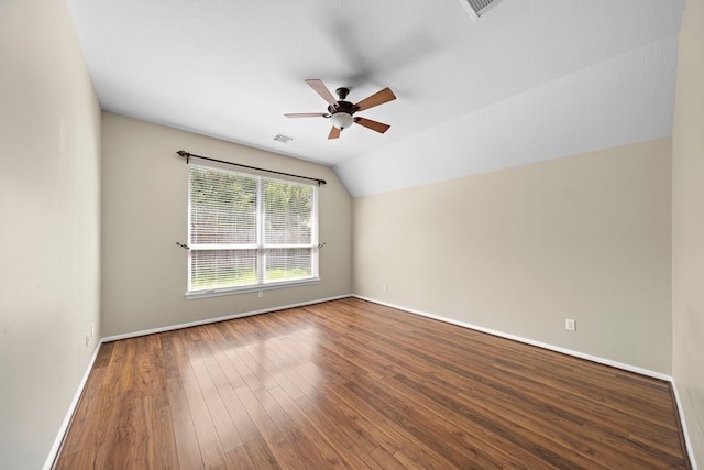 empty room with wood-type flooring, lofted ceiling, and ceiling fan