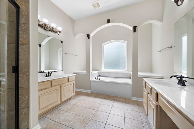 bathroom featuring tile patterned flooring, separate shower and tub, and vanity