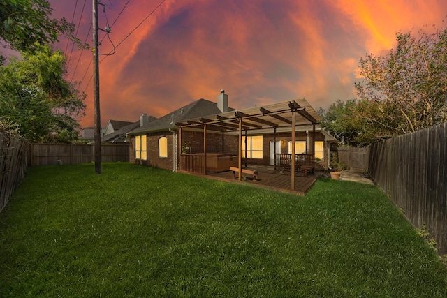 back house at dusk with a lawn and a patio area