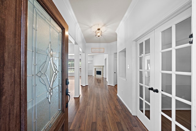 hallway with french doors, dark hardwood / wood-style floors, and ornamental molding