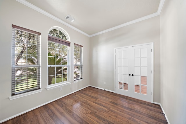 spare room with ornamental molding and dark hardwood / wood-style flooring