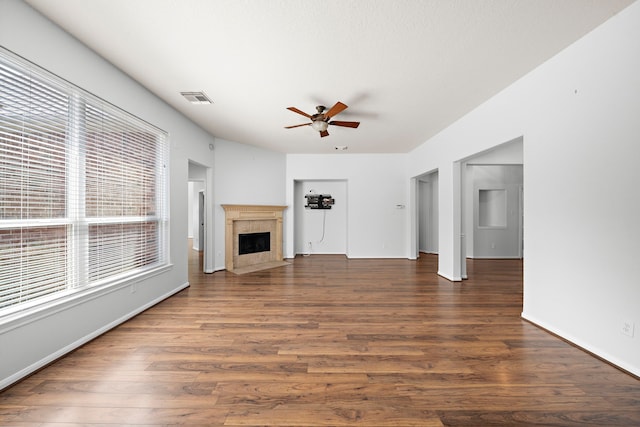 unfurnished living room with a fireplace, dark hardwood / wood-style floors, and ceiling fan