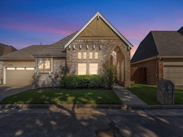 view of front of property with a lawn and a garage