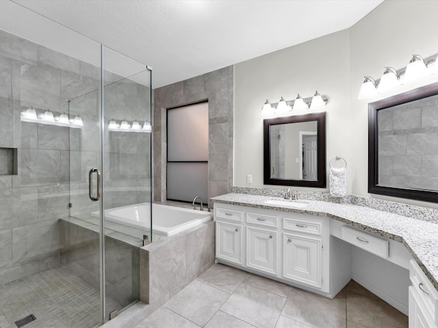 bathroom featuring tile patterned flooring, vanity, and shower with separate bathtub