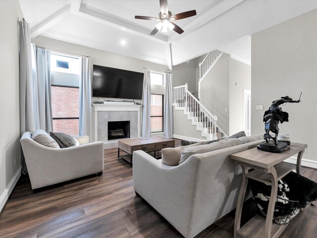 living room with a fireplace, dark hardwood / wood-style floors, and ceiling fan