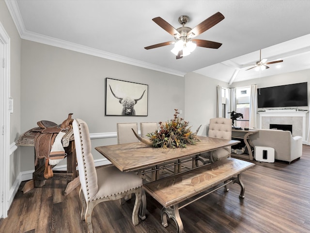 dining area with dark hardwood / wood-style flooring, ornamental molding, and a fireplace