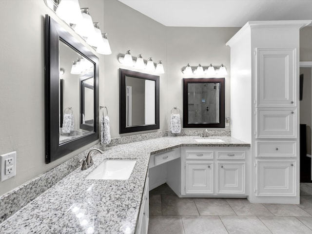 bathroom featuring tile patterned floors, vanity, and a shower