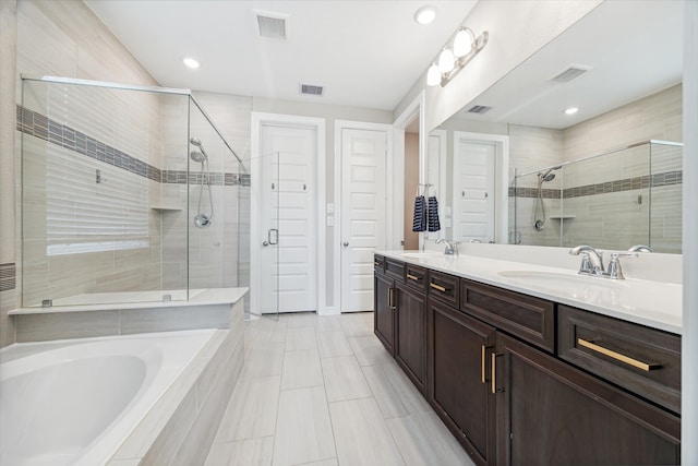 bathroom with tile patterned floors, vanity, and plus walk in shower