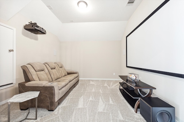 carpeted cinema room with lofted ceiling