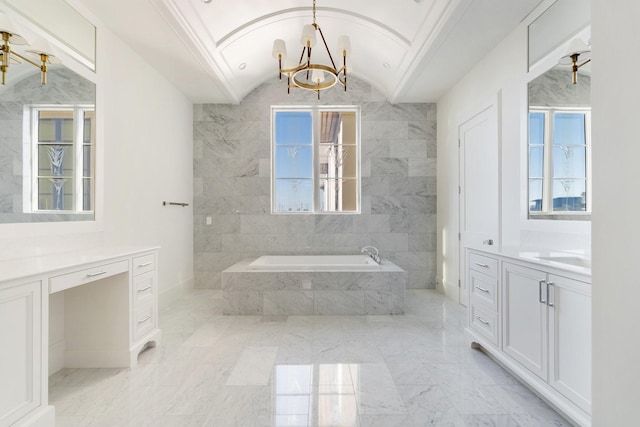 bathroom featuring vanity, a relaxing tiled tub, lofted ceiling, and an inviting chandelier