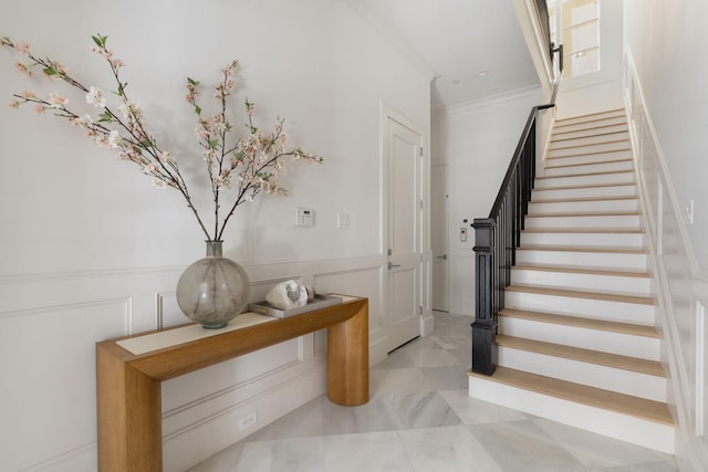 stairs featuring crown molding