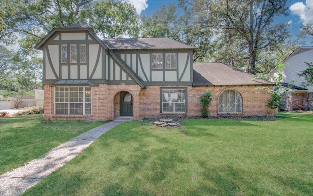 tudor house featuring a front lawn