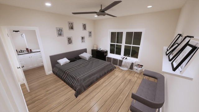 bedroom featuring sink, radiator, ceiling fan, and light hardwood / wood-style flooring