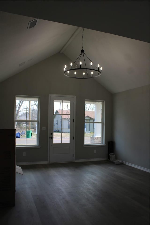 interior space featuring lofted ceiling, dark hardwood / wood-style floors, and a notable chandelier