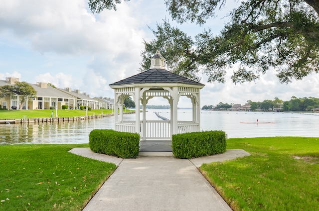 view of community featuring a water view, a gazebo, and a lawn