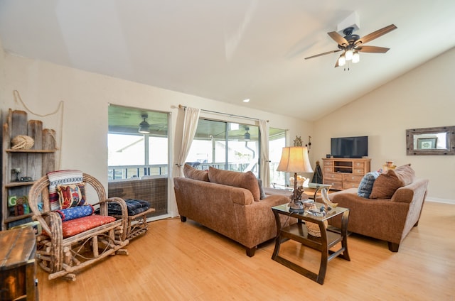 living room with lofted ceiling, light hardwood / wood-style floors, and ceiling fan