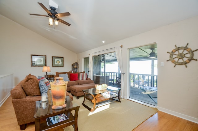 living room with lofted ceiling, ceiling fan, and light hardwood / wood-style flooring