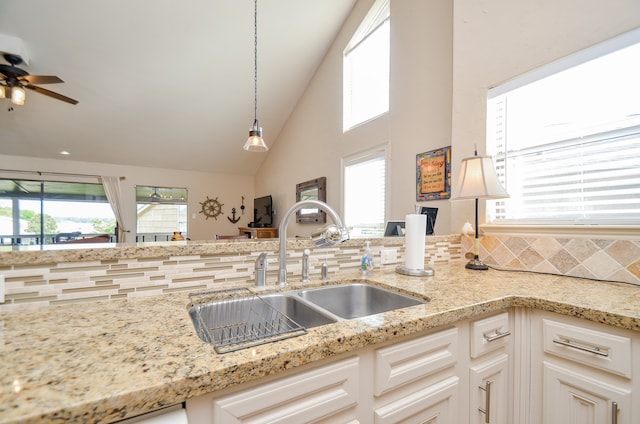 kitchen with white cabinets, plenty of natural light, and tasteful backsplash