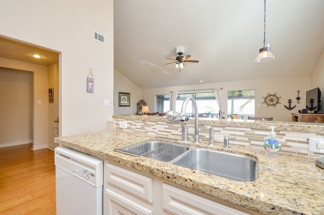 kitchen featuring white cabinets, sink, vaulted ceiling, light hardwood / wood-style flooring, and white dishwasher