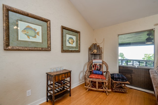 sitting room featuring lofted ceiling and hardwood / wood-style floors