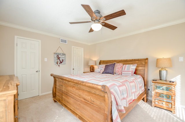 carpeted bedroom featuring ornamental molding and ceiling fan