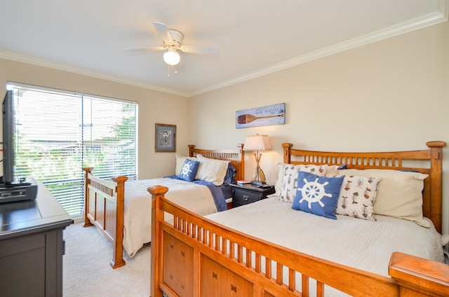 bedroom featuring ornamental molding, ceiling fan, and light colored carpet