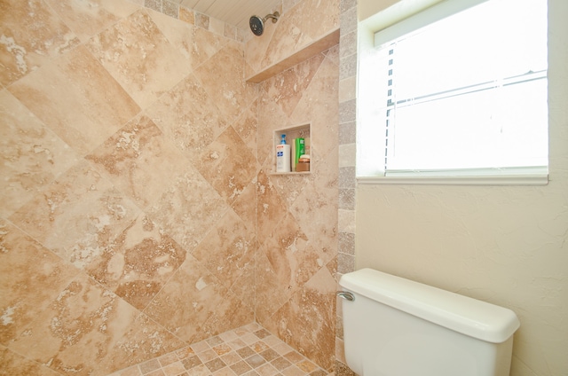 bathroom featuring toilet and tiled shower