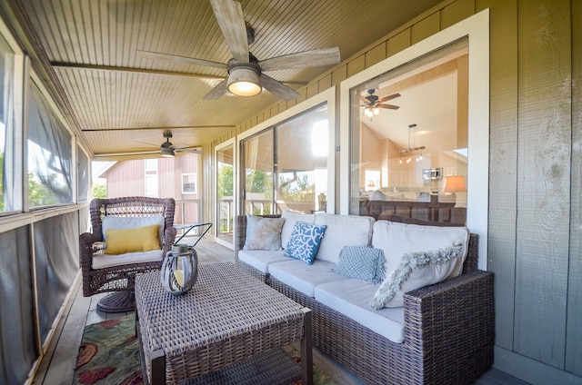 sunroom with ceiling fan and vaulted ceiling