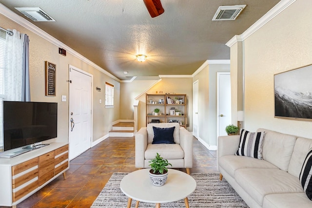 living room with ornamental molding, ceiling fan, and a textured ceiling