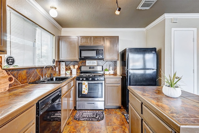 kitchen featuring black appliances, crown molding, sink, and tasteful backsplash