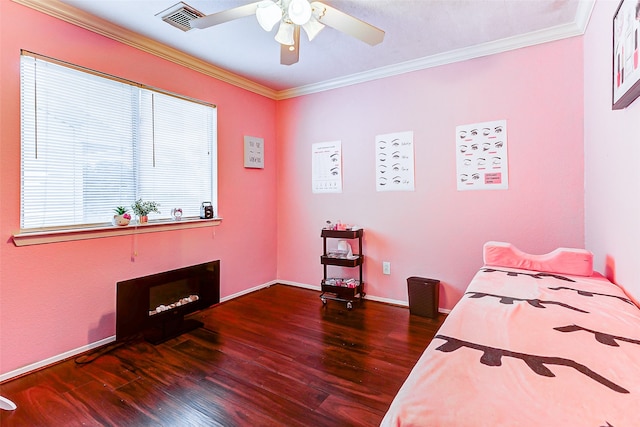 bedroom with ornamental molding, dark hardwood / wood-style flooring, and ceiling fan