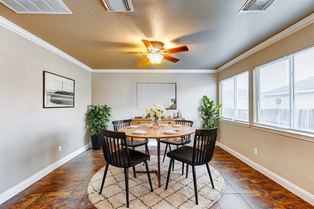 dining area featuring ceiling fan, ornamental molding, and a textured ceiling