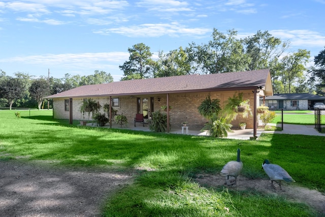 ranch-style house with a patio area and a front lawn