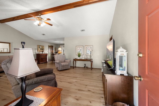 living room featuring lofted ceiling with beams, light wood-type flooring, and ceiling fan