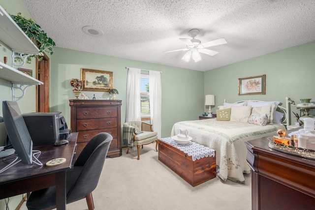 carpeted bedroom with a textured ceiling and ceiling fan