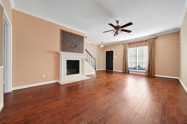 unfurnished living room featuring ornamental molding, ceiling fan, dark wood-type flooring, and a textured ceiling