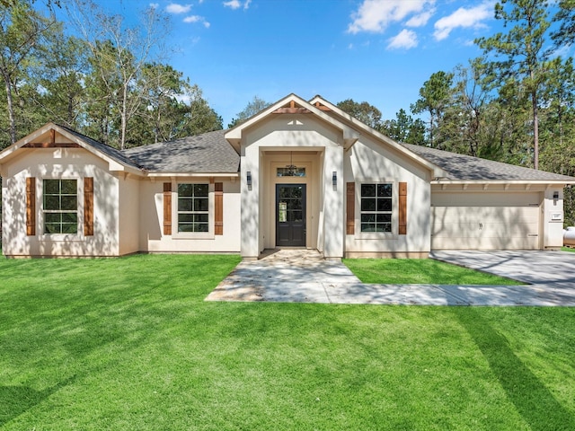 view of front of home with a garage and a front lawn