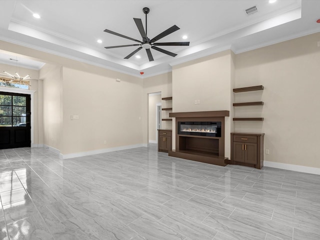 unfurnished living room with ornamental molding, a raised ceiling, and ceiling fan with notable chandelier