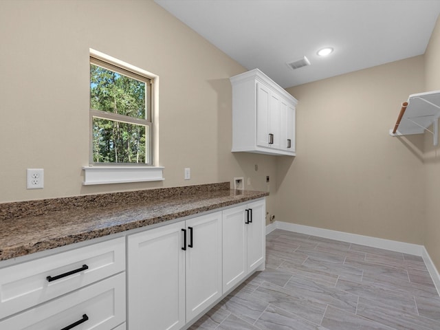 clothes washing area with cabinets, washer hookup, and hookup for an electric dryer