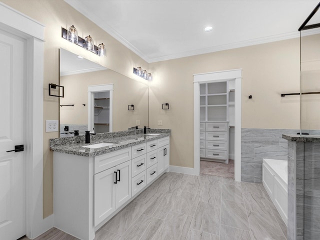 bathroom featuring vanity, a tub, and ornamental molding