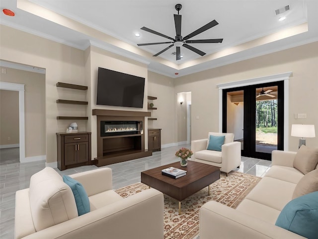 living room with crown molding, a raised ceiling, and ceiling fan