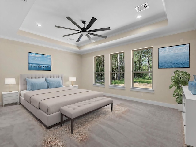 bedroom featuring a raised ceiling, ornamental molding, light carpet, and ceiling fan